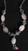 A modern silver necklace with chain links having faceted cut frosted stones and ball finials
FREE