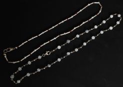 2 contemporary silver necklaces, one beaded, the other with cylindrical spacers.