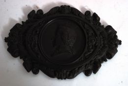 A rare and unusual large 19th century bois durci plaque of WA Mozart.