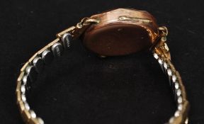 A 9ct gold ladies cocktail dress watch by Renown having 15 jewel movement set on rolled gold