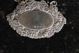 A hallmarked silver bottle label, along with a Coalport china hanging bottle label .
