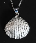 An unusual silver shell containing a freshwater pearl. Total weight 12.