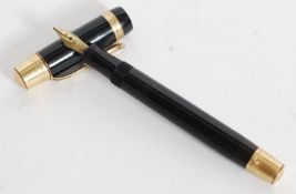 A vintage Kaweco black and rococo chase gold trim fountain pen with a 14ct gold nib.