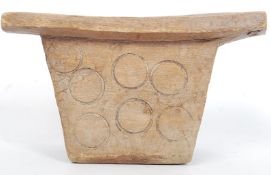 An East African Tribal stool raised on double supports carved with circular motifs.