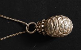 A stunning silver and white metal pineapple pendant and necklace.