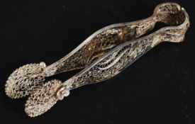 A 20th century silver continental filigree worked pair of sugar tongs of high decorative form.