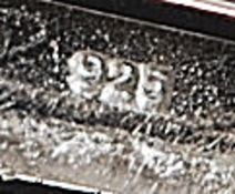 A ladies decorative silver and cz stone inset bangle with bow decoration to centre. Total weight 17.