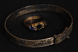 A silver  rococo chased christening bracelet together with a 9ct gold ladies ring with blue