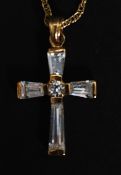 A 9ct gold crucifix pendant necklace and chain. The crucifix inset with CZ baguette stones.