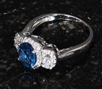A ladies 925 silver cz stone and blue topaz 3 stone dress / cocktail ring. Total weight 4.2g Size R.