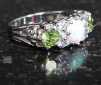 A silver CZ and opal peridot set dress ring. Total weight 4.8g / Size Q.5.