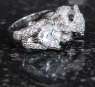 A silver and cz cartier style panther ring with sapphire eyes. Total weight 12.