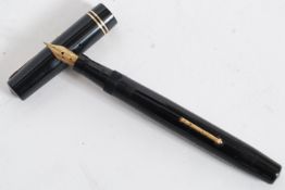 A vintage Mable Todd & Co Swan Self Filler Fountain pen in a black case with gold trim having Swan
