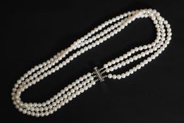 A freshwater pearl 3 string necklace with white metal barrel clasp.