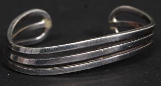 A ladies silver 925 triple split stem bracelet of swirl contemporary form.
