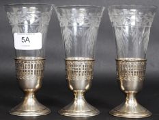 A run of 3 cut glass and silver stirrup cups. Marked Sterling 8186 with laurel wreath.