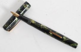 A vintage Mable Todd & Co Swan Self Filler Fountain pen in a marble effect cap and stem with marble