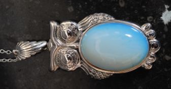 A silver and moonstone owl pendant necklace.