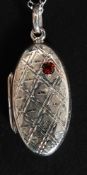 A silver locket with garnet on silver chain. Total weight 5.