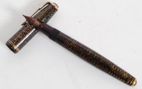 A 1936  Canadian striped gold Parker Vacumatic fountain pen with arrow parker nib.