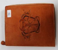 An Art Nouveau leather embossed personal organiser with sectional interior marked to the inside