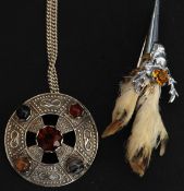 A contemporary silver necklace and celtic style silver pendant.