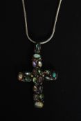 A contemporary silver Omega linked fine necklace and crucifix pendant with inset coloured stones.