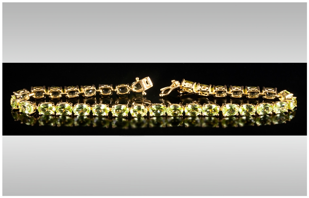 Peridot Tennis Bracelet, oval cut peridots totalling 15cts set in gold vermeil and silver in a