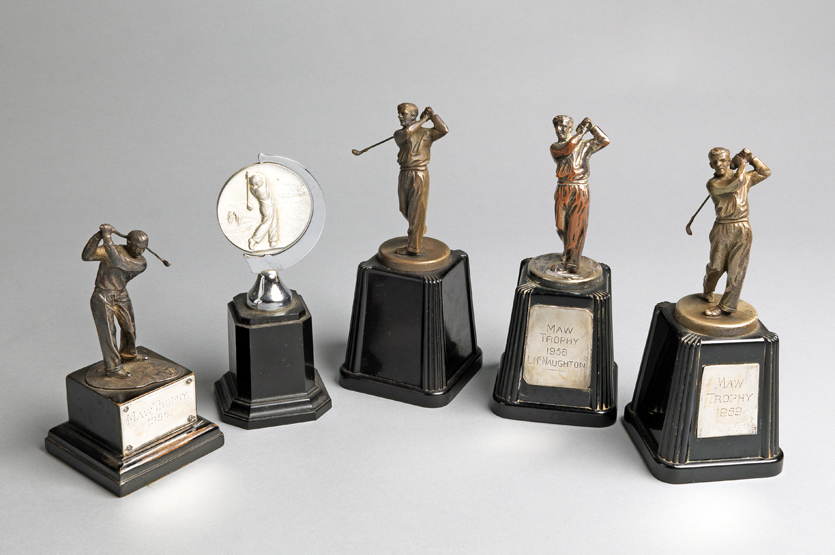 A group of five golf trophies, including three set with plaques inscribed for the Maw Trophy with