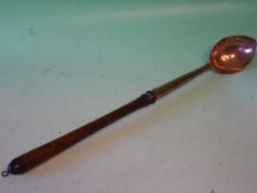 A Copper Straining Spoon With turned treen handle. 18th century. 20
