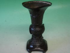 A Japanese Bronze Vase Meiji. With flared rim, decorated with spiral roundals and animals, raised in