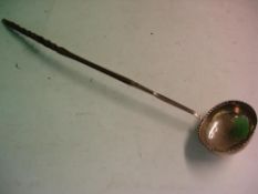A Silver Punch Ladle with twisted whalebone handle, the oval bowl with crimped rim. London 1785-
