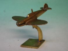 A Brass Spitfire Desk Weight Raised on a stand. 6