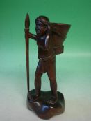 An Ethnic Carved Hardwood Figure A man with a basket and spear. 11