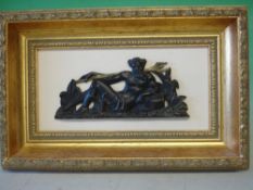 A Bronze Plaque of Neptune lying amongst foliage with a gilded trident. Framed and mounted. 6