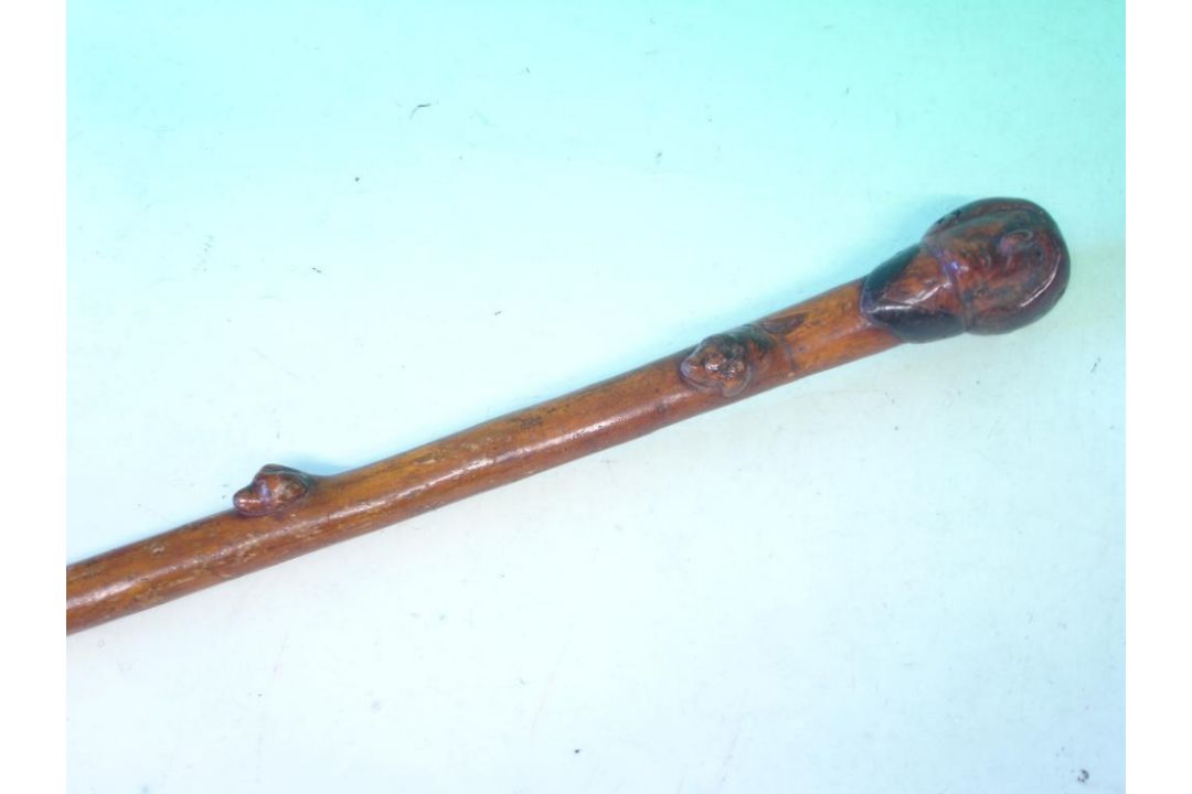 A Fruitwood Walking Cane The grip carved as head of George Washington, the shaft with five hound's