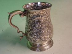 An Early George 111 Silver Mug Profusely embossed and chased with C scrolls, rockwork, vine fruits