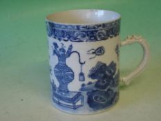 A Chinese Blue and White Mug Painted with vase, flowers, foliage and flying insects. The handle
