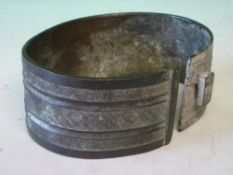 An Oriental Bronze Armlet With diaper or flower head decorated bands. 4 ¾
