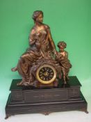 A French Mantle Clock Black slate and speltar. Surmounted by a classical lady teaching a child to