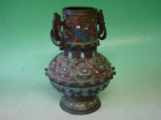 A Japanese Bronze Vessel Of archaic form, decorated in relief with animals, figures and geometric