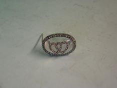 A Moonstone and Diamond Brooch The oval cabochon applied with a pair of interlocking diamond