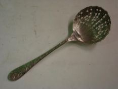 A White Metal Sifter Spoon With shell form bowl, the handle relief decorated with birds and foliage.