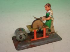 An Arnold Tinplate Clockwork Toy The scissor sharpener, U.S. zone Germany. 5 ¾