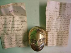 A 19th Century Brass Box The hinged lid cast with a female mask and stamped 