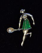 Silver and enamel ladies tennis brooch - depicting a lady playing a fore-hand shot - cased