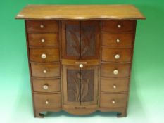 A Walnut Jewellery Chest with two flights of six drawers, flanking two cabinets each enclosed by a