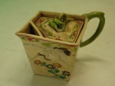 An Oriental Teapot of square form, decorated in coloured enamels with crane, foliage and flying