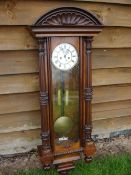 A Walnut Viennese Regulator. Two train weight driven movement striking on a coiled gong, the two