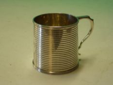 A Silver Mug. The slightly tapered body with reeded bands, oval cartouche engraved 
